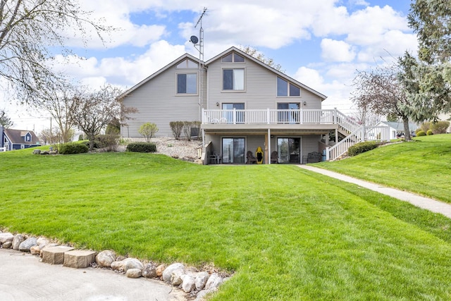 9015 Kingsley Dr, Onsted, MI 49265 - rear view of house featuring a lawn, a deck, and stairs