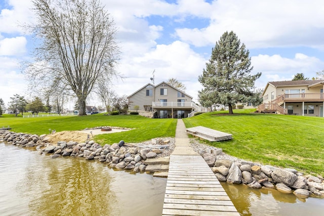 9015 Kingsley Dr, Onsted, MI 49265 - view of dock with a yard, stairs, a deck with water view, and a fire pit