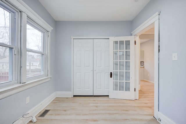 849 Chalmers St, Detroit, MI 48215 - unfurnished bedroom with visible vents, a closet, light wood-style flooring, and baseboards