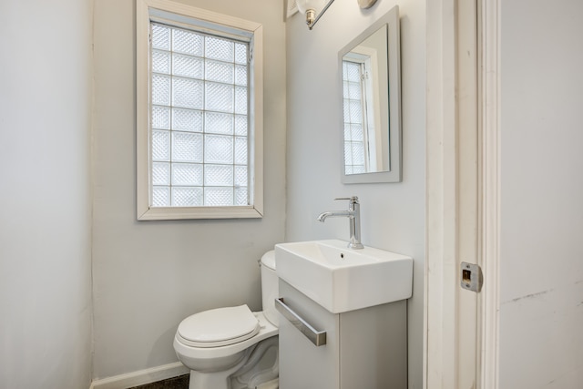 849 Chalmers St, Detroit, MI 48215 - bathroom featuring toilet, vanity, and plenty of natural light