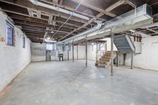 849 Chalmers St, Detroit, MI 48215 - basement featuring heating unit, water heater, stairs, and brick wall