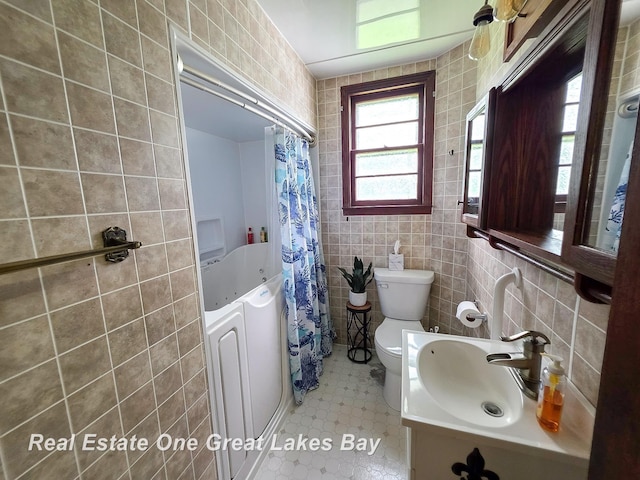 1520 Coolidge Ave, Saginaw, MI 48638 - bathroom featuring tile walls, tile patterned flooring, and vanity