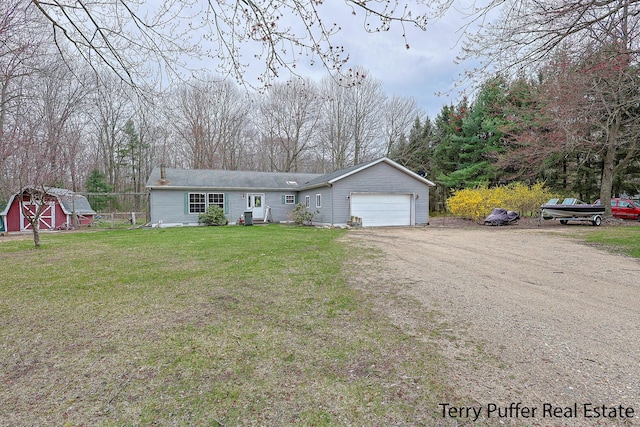 22 N Bossett Rd, Ravenna, MI 49451 - ranch-style home with a storage unit, dirt driveway, a front lawn, and a garage