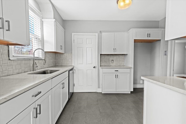 18603 Monica St, Detroit, MI 48221 - kitchen featuring backsplash, dishwasher, a sink, and white cabinetry