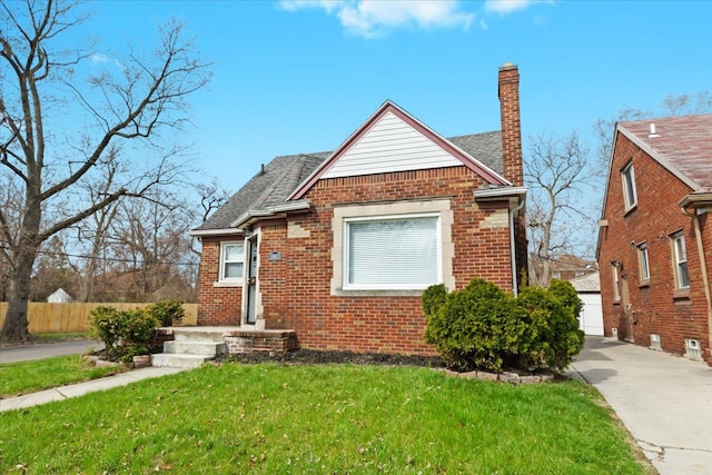 18603 Monica St, Detroit, MI 48221 - bungalow-style house featuring a chimney, brick siding, fence, roof with shingles, and a front lawn
