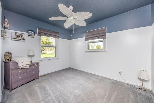7364 Regency Ln, Canadian Lakes, MI 49346 - unfurnished bedroom with carpet flooring, baseboards, visible vents, and ceiling fan