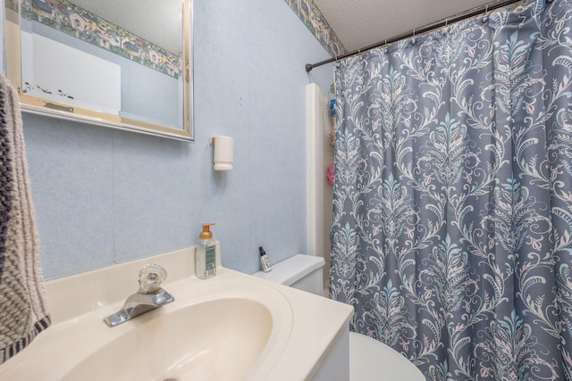7364 Regency Ln, Canadian Lakes, MI 49346 - bathroom featuring vanity, a textured ceiling, a shower with shower curtain, and toilet