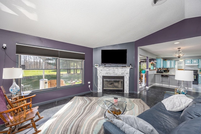 7364 Regency Ln, Canadian Lakes, MI 49346 - living area with baseboards, a chandelier, vaulted ceiling, and a tile fireplace