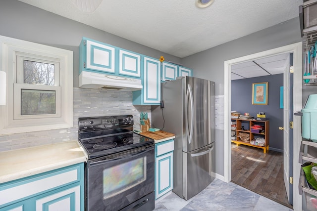 7364 Regency Ln, Canadian Lakes, MI 49346 - kitchen with freestanding refrigerator, black electric range oven, light countertops, under cabinet range hood, and backsplash