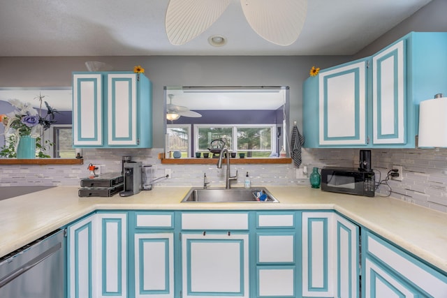 7364 Regency Ln, Canadian Lakes, MI 49346 - kitchen featuring stainless steel dishwasher, decorative backsplash, black microwave, blue cabinets, and a sink