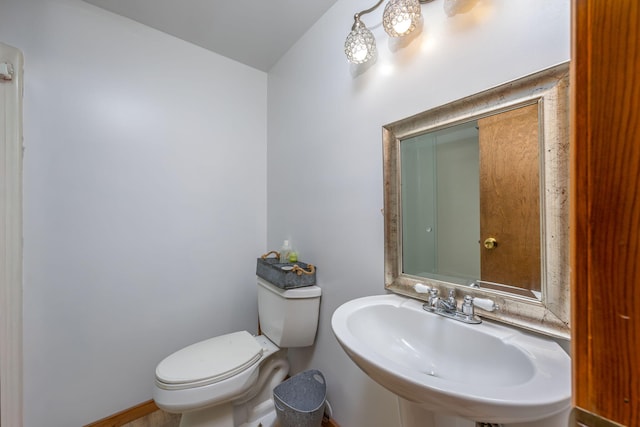 7364 Regency Ln, Canadian Lakes, MI 49346 - half bathroom with a sink, baseboards, and toilet