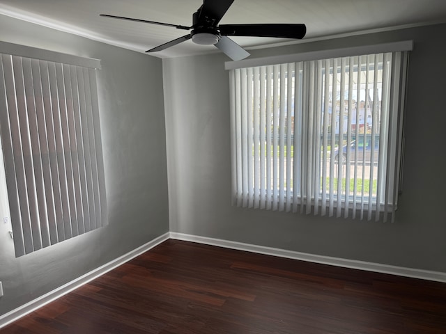 spare room with baseboards, wood finished floors, a ceiling fan, and plenty of natural light