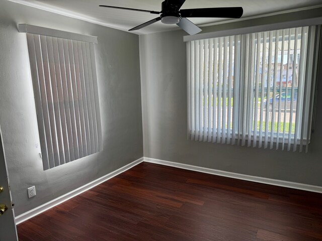 empty room featuring ceiling fan, wood finished floors, and baseboards