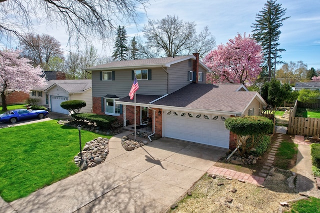 traditional home with a garage, fence, a front yard, brick siding, and concrete driveway