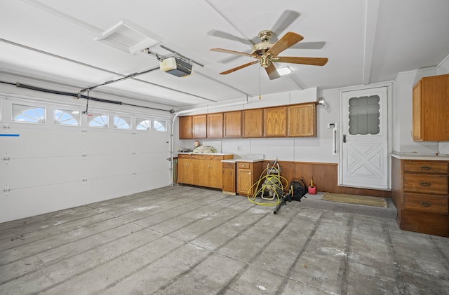 garage with a garage door opener and a ceiling fan