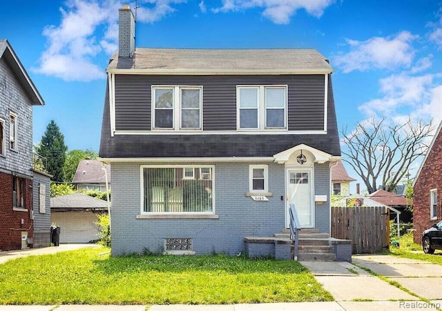 view of front of home with fence, a chimney, brick siding, and a front lawn