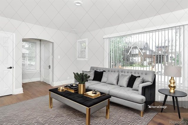living room with baseboards, wood finished floors, and plenty of natural light