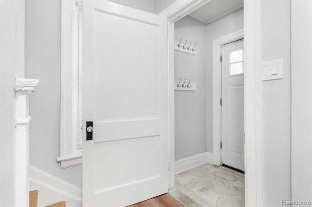 interior space with marble finish floor and baseboards
