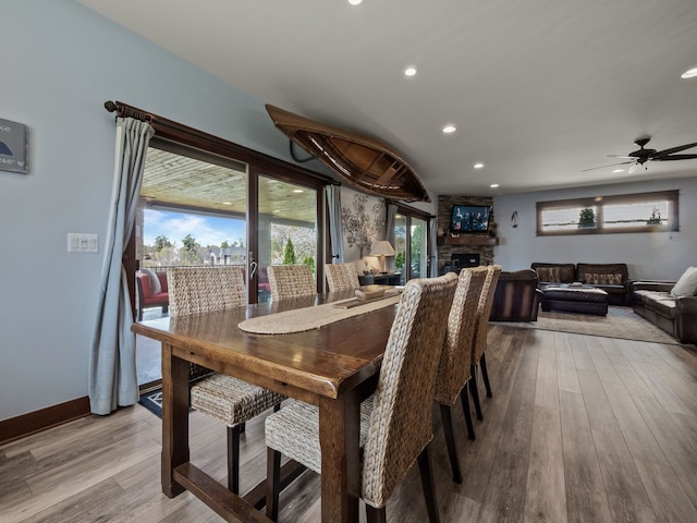 3190 Edgewood Park Dr, Commerce Twp, MI 48382 - dining space with wood finished floors, baseboards, a stone fireplace, recessed lighting, and a ceiling fan