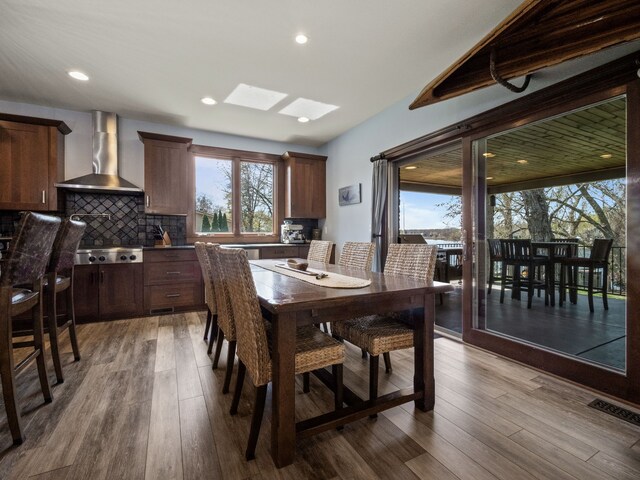 3190 Edgewood Park Dr, Commerce Twp, MI 48382 - dining area with a skylight, recessed lighting, dark wood finished floors, and visible vents