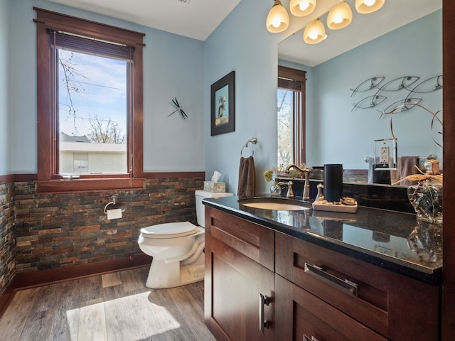 3190 Edgewood Park Dr, Commerce Twp, MI 48382 - bathroom featuring tile walls, wood finished floors, a wainscoted wall, vanity, and toilet