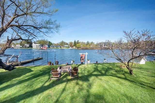 3190 Edgewood Park Dr, Commerce Twp, MI 48382 - dock area featuring a lawn and a water view