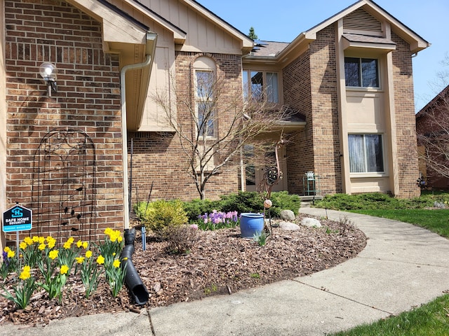 6358 Timberwood S, West Bloomfield, MI 48322 - view of side of property with board and batten siding and brick siding