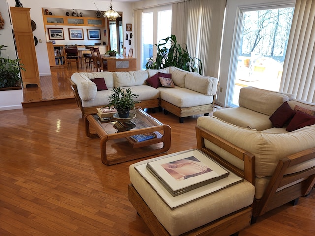 6358 Timberwood S, West Bloomfield, MI 48322 - living room with a notable chandelier and hardwood / wood-style floors