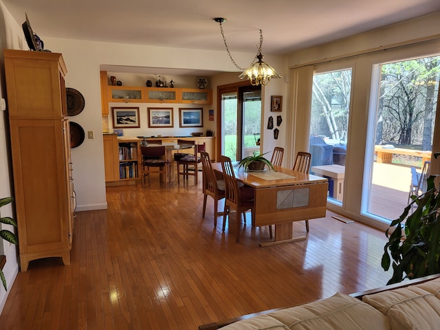 6358 Timberwood S, West Bloomfield, MI 48322 - dining room featuring wood-type flooring, baseboards, a chandelier, and visible vents