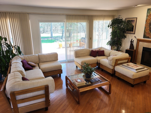 6358 Timberwood S, West Bloomfield, MI 48322 - living area featuring wood-type flooring, a wealth of natural light, and a tile fireplace