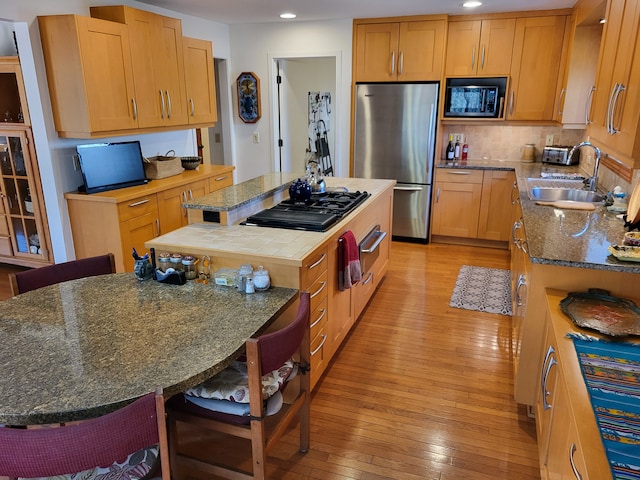 6358 Timberwood S, West Bloomfield, MI 48322 - kitchen with a center island, light wood-type flooring, a sink, freestanding refrigerator, and black gas stovetop