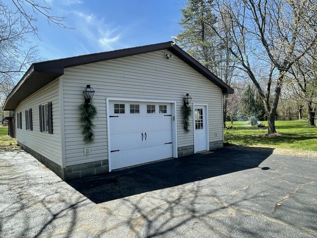 331 Jonesville Rd, Jonesville, MI 49250 - view of property exterior featuring a detached garage and an outbuilding