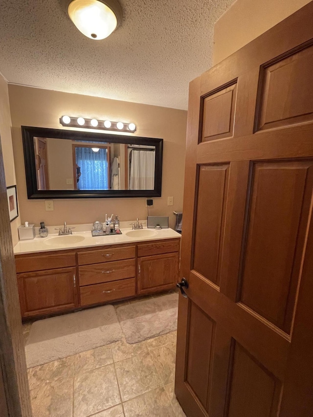331 Jonesville Rd, Jonesville, MI 49250 - full bath with double vanity, a textured ceiling, and a sink