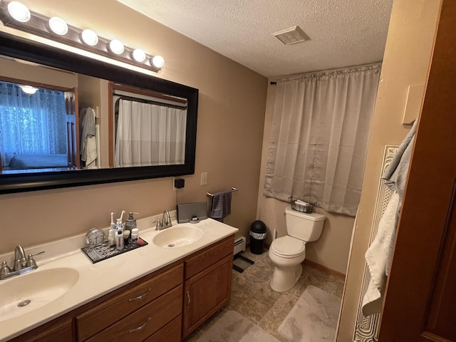 331 Jonesville Rd, Jonesville, MI 49250 - full bathroom featuring double vanity, a sink, a textured ceiling, and toilet