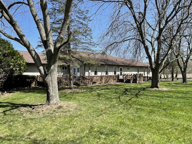 331 Jonesville Rd, Jonesville, MI 49250 - exterior space with a wooden deck, a yard, and brick siding