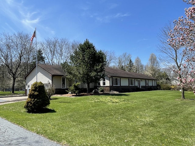 331 Jonesville Rd, Jonesville, MI 49250 - ranch-style house featuring a front lawn and brick siding
