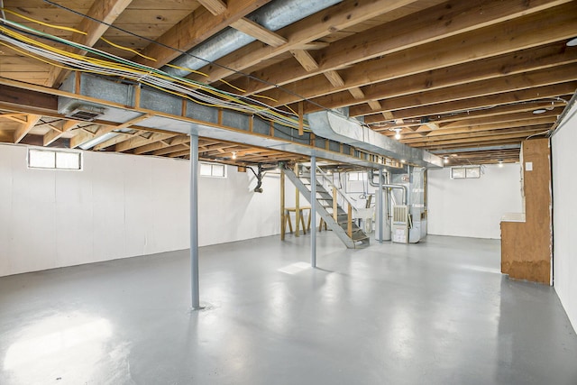 basement with stairway and heating unit