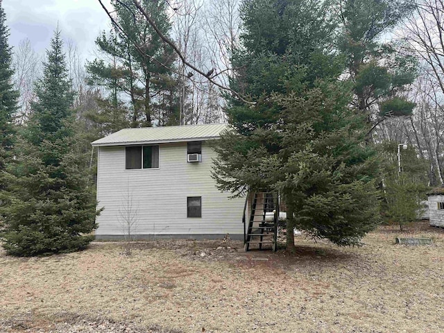 2934 River Ridge Rd, Alger, MI 48610 - view of property exterior featuring metal roof and stairway