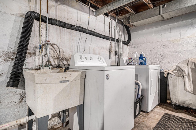 laundry room featuring separate washer and dryer, a sink, and laundry area