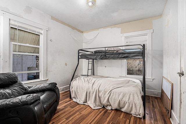 bedroom featuring wood finished floors and baseboards