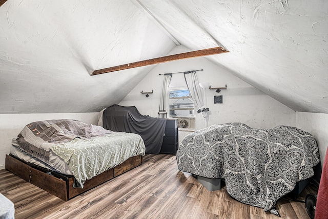 bedroom featuring wood finished floors and vaulted ceiling