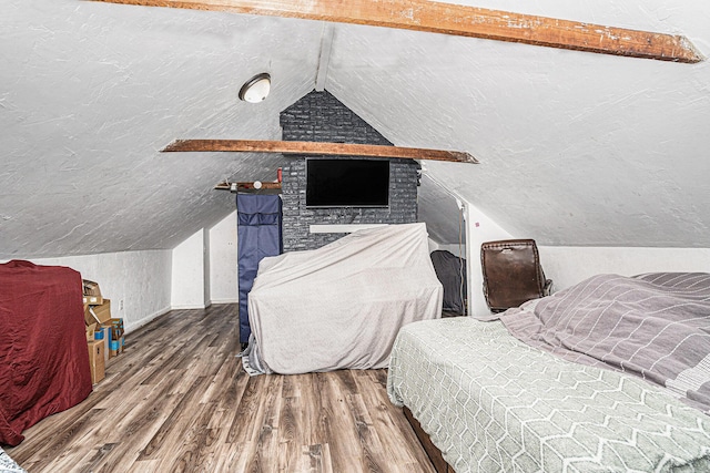 bedroom featuring wood finished floors and vaulted ceiling
