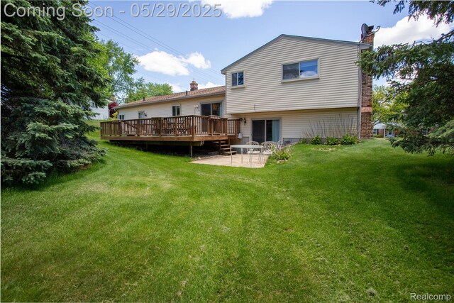 140 Indian Knolls St, Oxford, MI 48371 - back of house featuring a chimney, a patio area, a wooden deck, and a yard