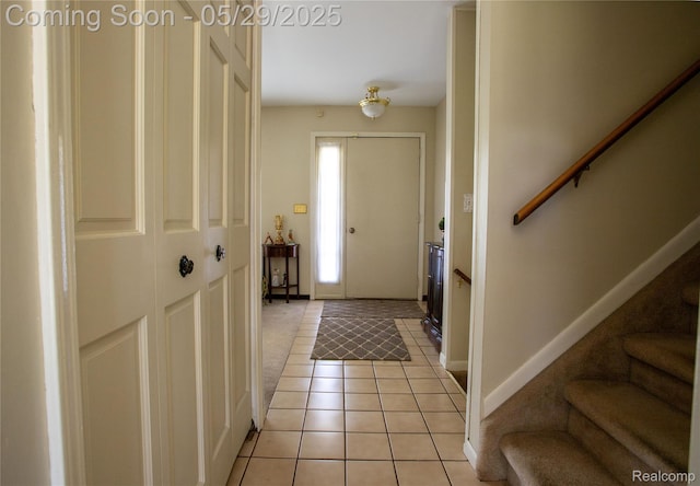 140 Indian Knolls St, Oxford, MI 48371 - entrance foyer featuring stairs, light tile patterned flooring, baseboards, and light colored carpet