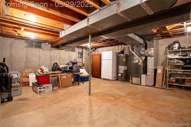 140 Indian Knolls St, Oxford, MI 48371 - unfinished basement with freestanding refrigerator, water heater, and heating unit