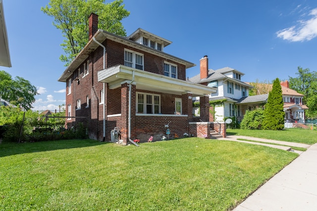 214 Worcester, Highland Park, MI 48203 - american foursquare style home featuring brick siding, a chimney, and a front lawn