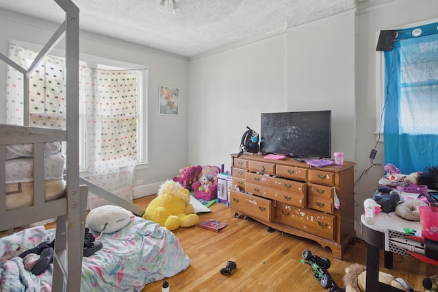214 Worcester, Highland Park, MI 48203 - bedroom featuring wood finished floors, a textured ceiling, and multiple windows