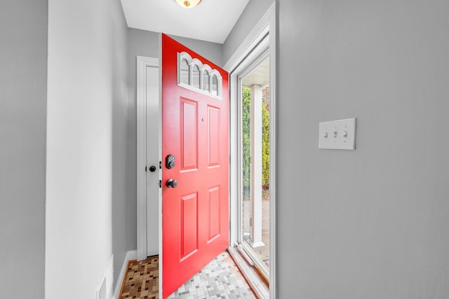 foyer with baseboards and tile patterned floors