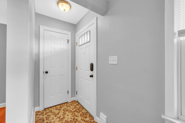 entrance foyer featuring baseboards and light floors