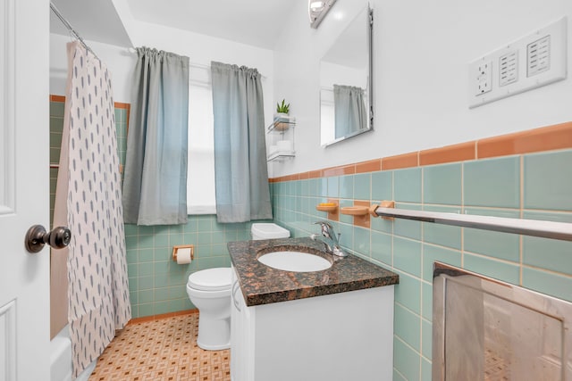 full bathroom with toilet, tile walls, a shower with shower curtain, and vanity